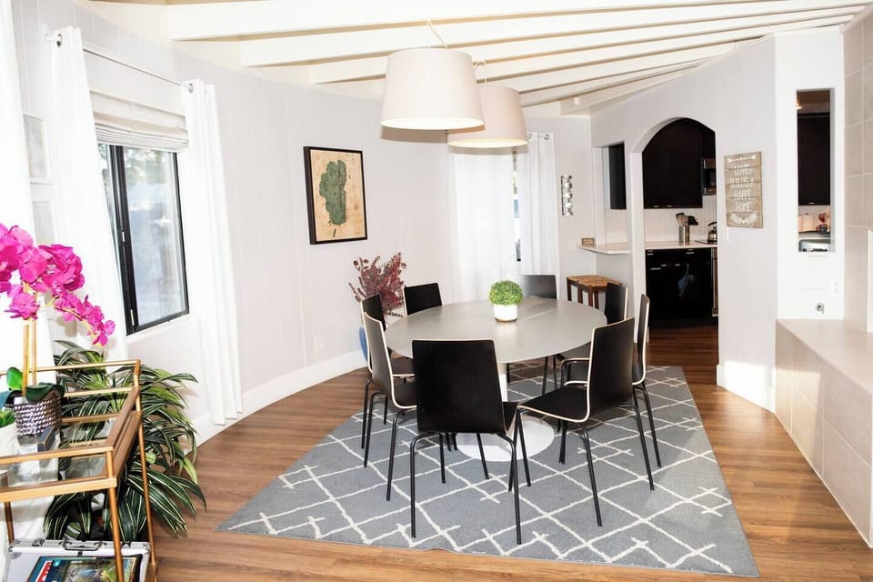 In the dining area is a nice, large round dining table that can seat up to eight people. The hanging overhead lamps give a nice ambiance.