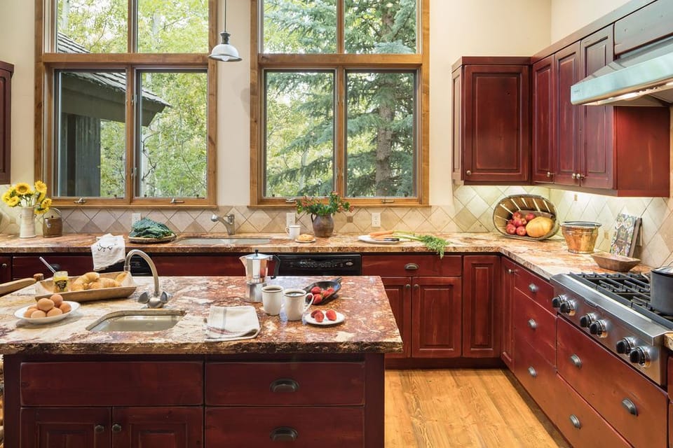Gather around the granite island for meals prepped in the chef's kitchen, custom cabinetry lining the walls.