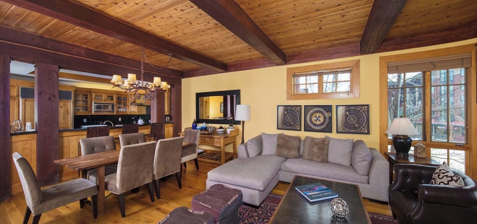 Gas fireplace and floor-to-ceiling windows anchor the open-plan great room.