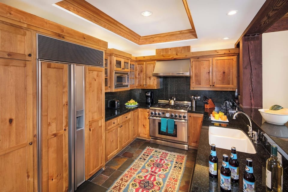 Bar seating lines the fully equipped kitchen for casual meals.