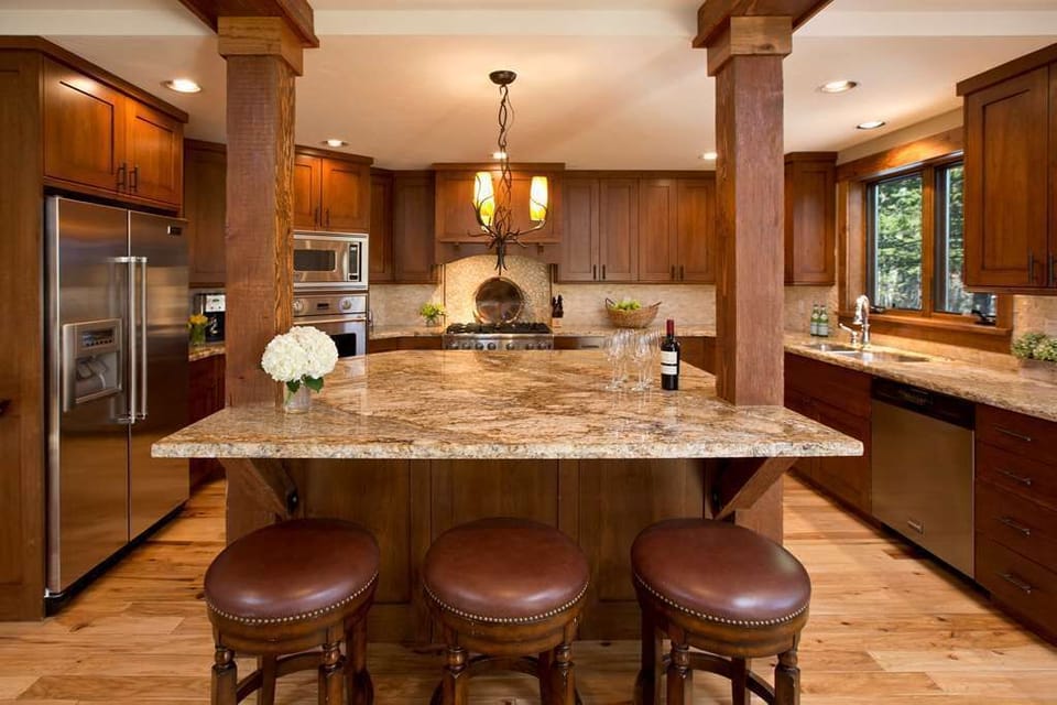 Prepare meals at the kitchen island, backed by wood cabinetry and full-size appliances.