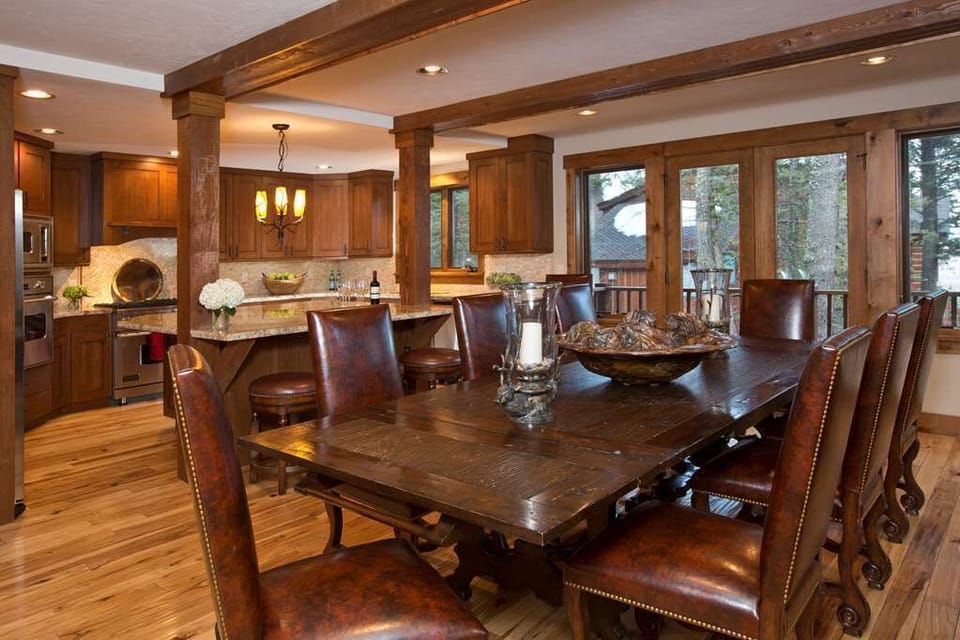 Gather around the wood dining table for meals from the chef's kitchen, equipped with professional-grade appliances.