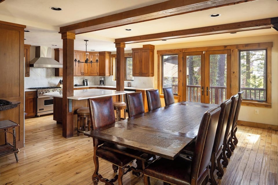 Professional-grade appliances equip the chef's kitchen beside the dining area.