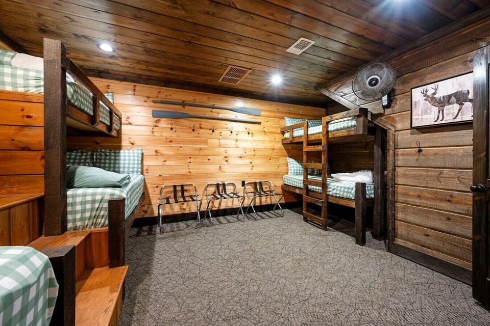 Bunk room with lounge seating, TV, and flexible sleeping space.
