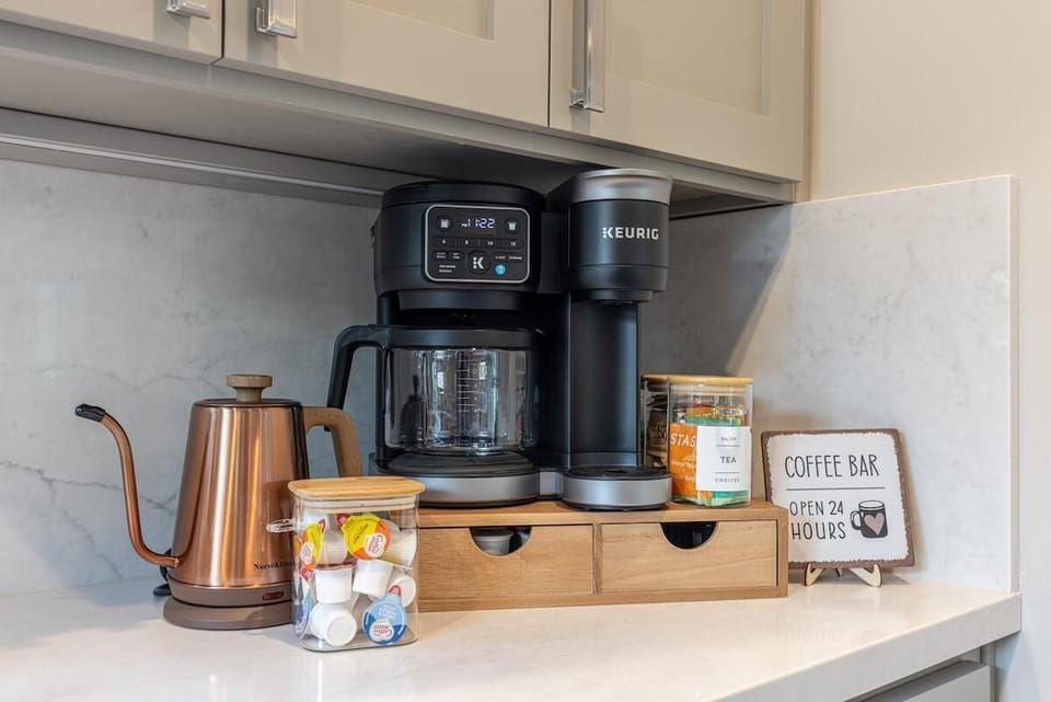 Inviting coffee bar with drip maker, Keurig, kettle, and tea options