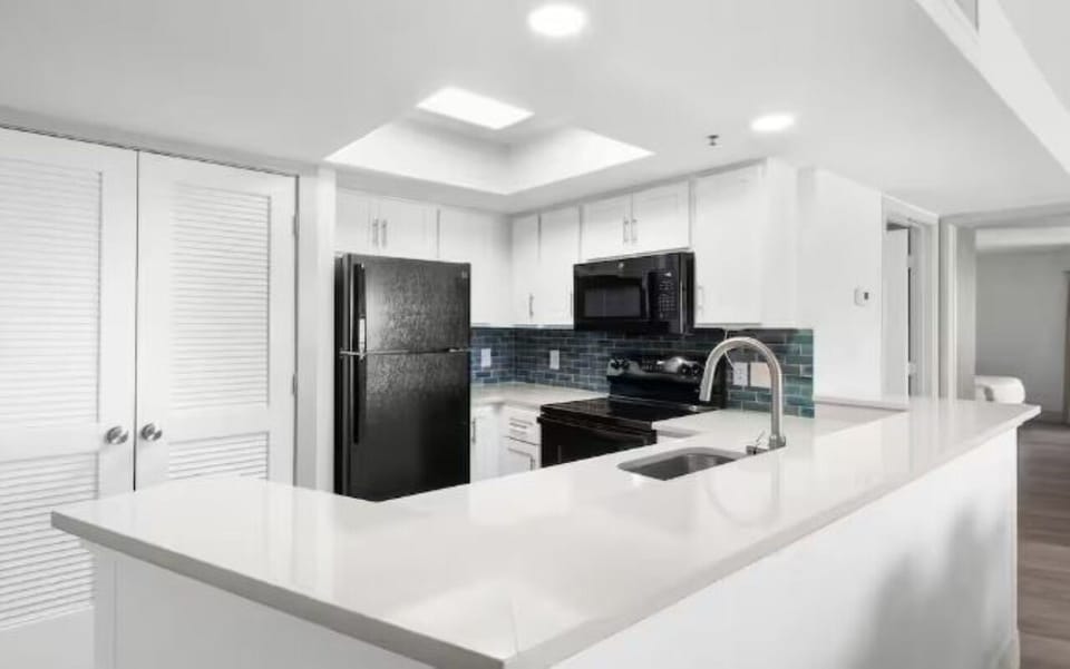 Prepare quick breakfasts on glossy counters with ample workspace.