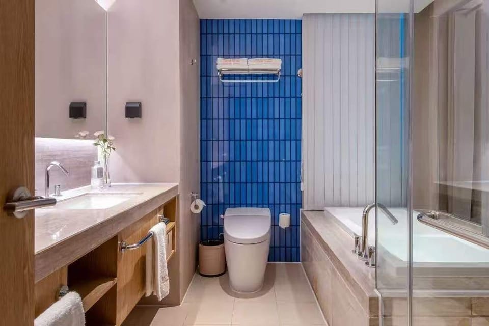 Separate tub and shower, rainfall showerhead, designer toiletries