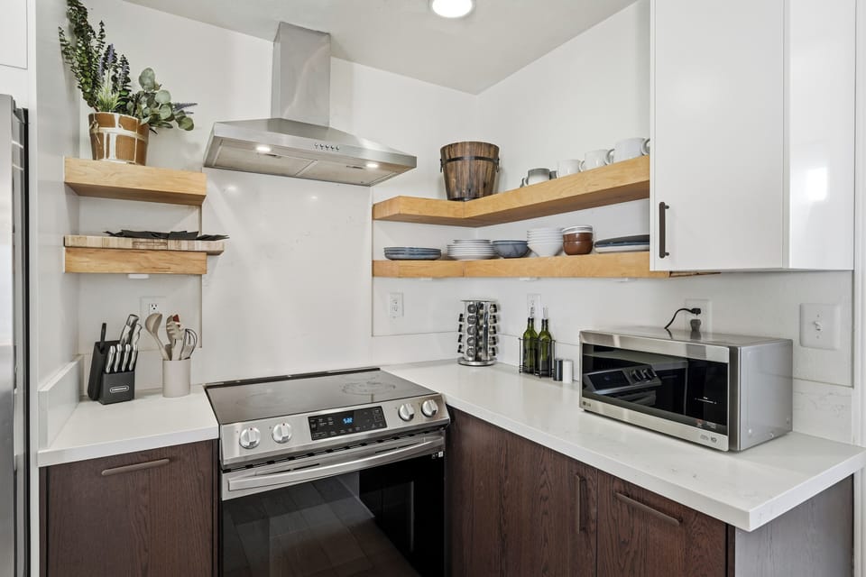 Modern kitchen with open shelving and stainless steel appliances
