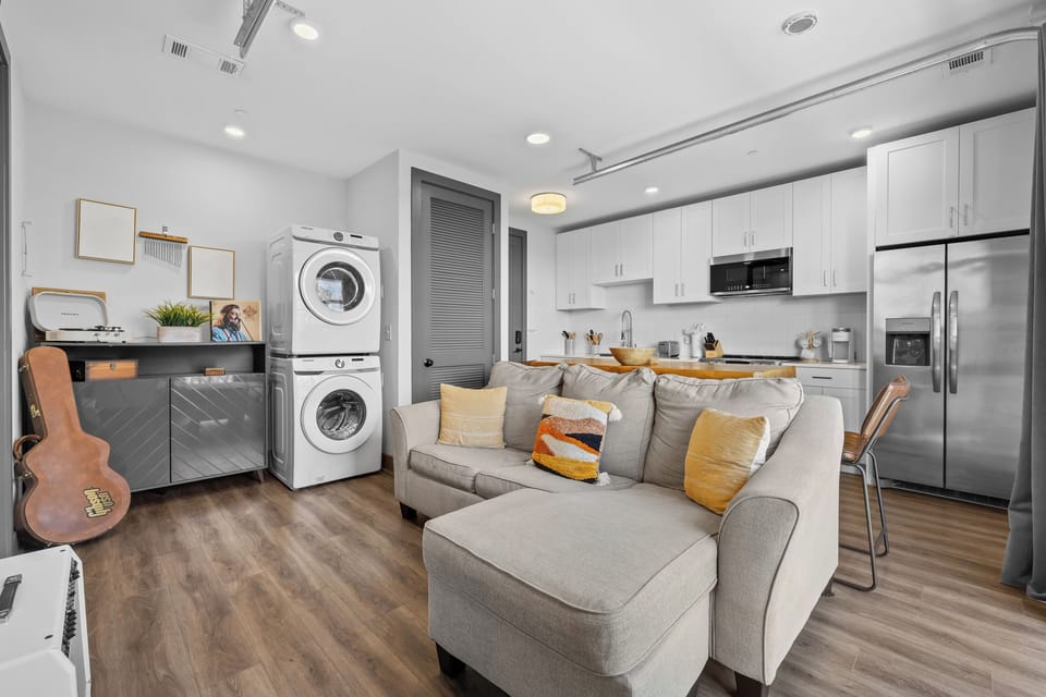 Living Room: Modern charm with natural light, chic decor, and a guitar waiting for your tunes!