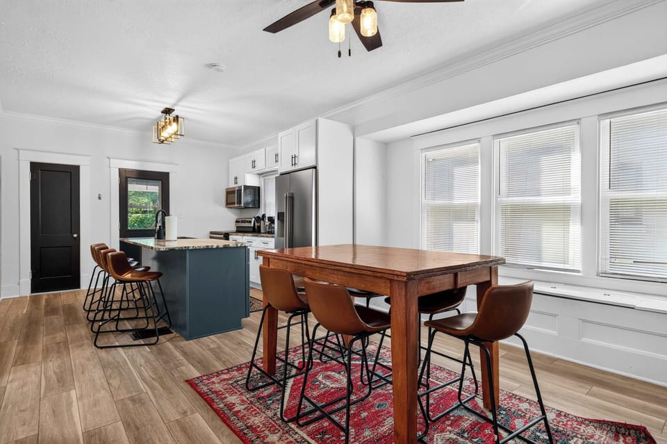 Dining Area: Gather around the inviting dining table for family meals, morning coffee, or game nights in a bright and welcoming space designed for shared moments together.
