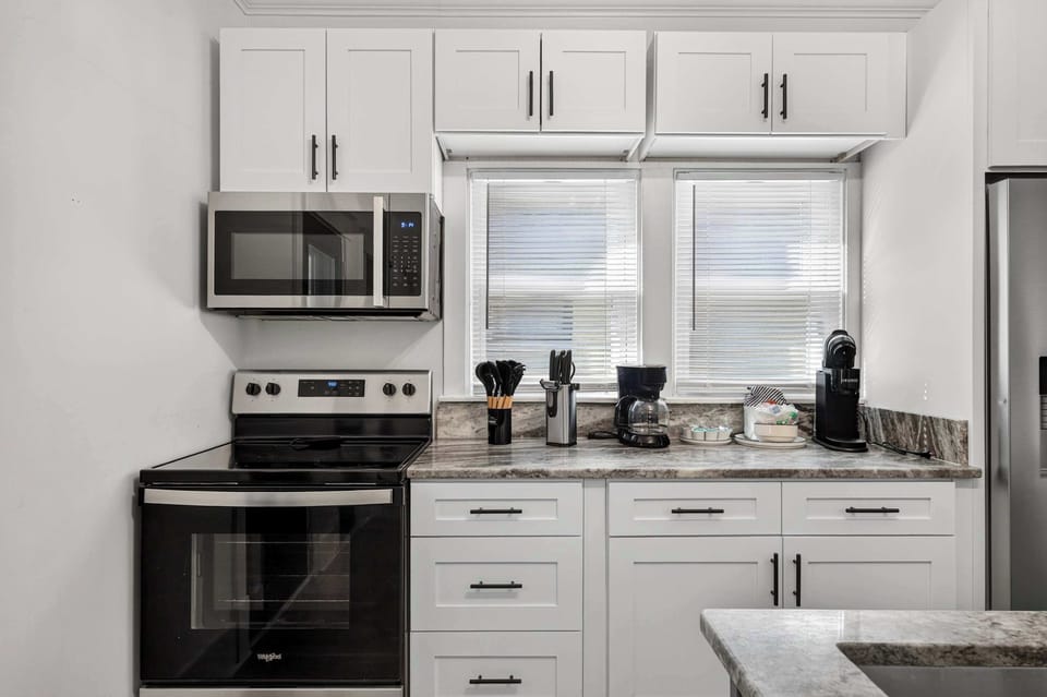 Kitchen: Prepare everything from quick breakfasts to family dinners in this fully equipped kitchen featuring modern appliances, ample counter space, and essential cookware.