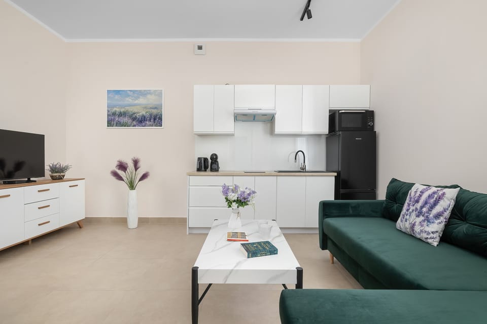 A stylish lounge area with a sofa and TV. Relax and enjoy your free time in comfort.