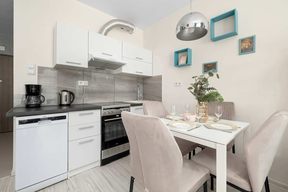 The bright kitchenette offers all the essentials for cooking during your stay. A cozy dining table provides the perfect spot for shared meals.