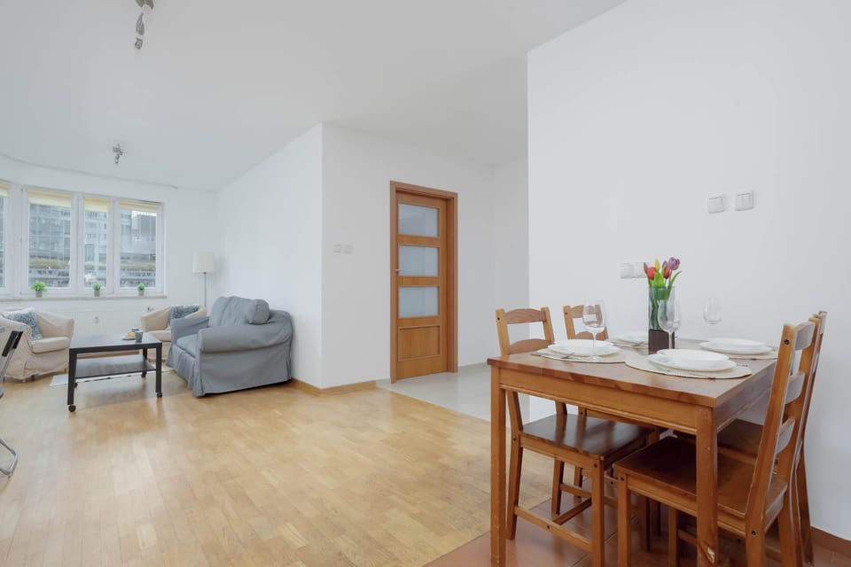 A dining table set beside the living room creates a comfortable place for meals. Enjoy breakfast, lunch, or dinner together.