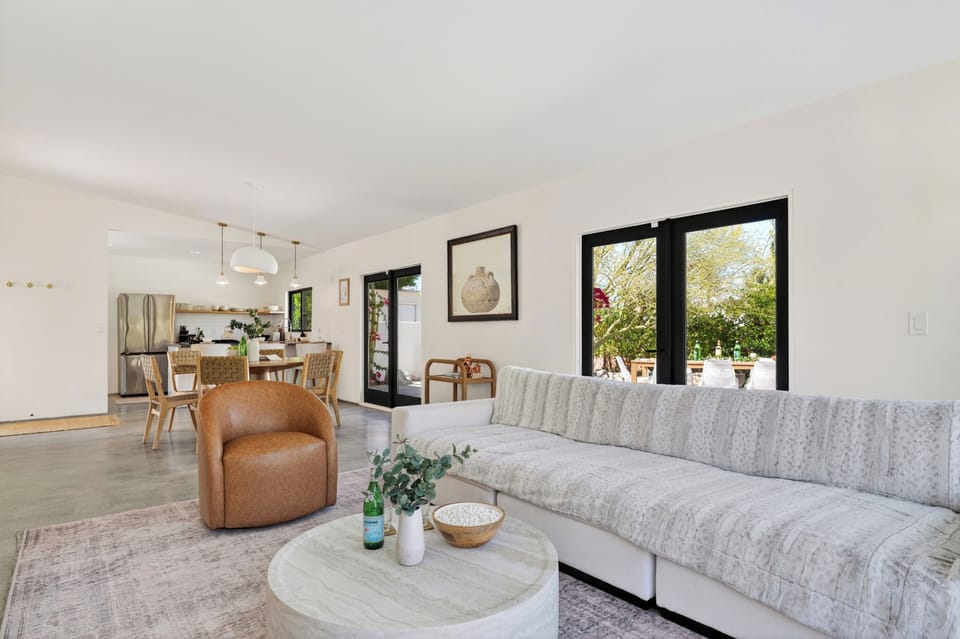 Expansive open-floor plan connecting the living area directly to the dining room and kitchen.