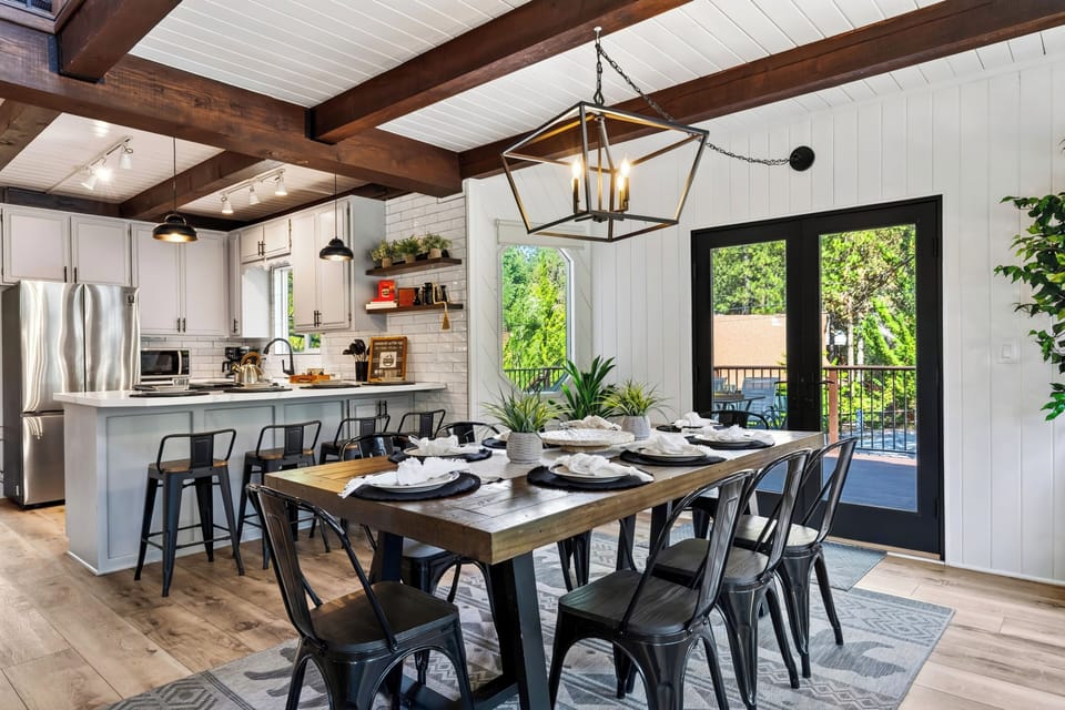 Gather for meals in the open dining area, with breakfast-bar seating and direct access to the deck.