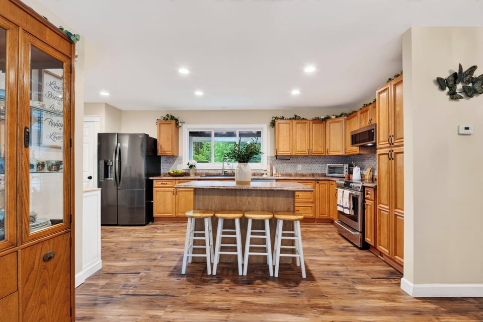 Fully equipped kitchen with a functional layout, stainless steel appliances, and ample prep space.