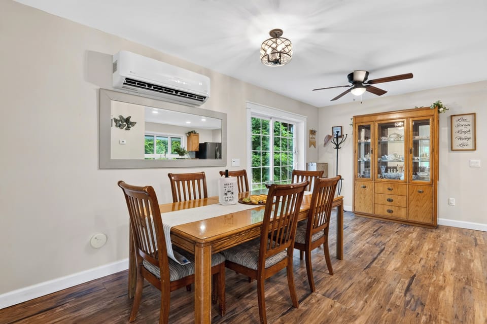 Bright and airy formal dining room equipped with a modern split-system AC for year-round comfort.