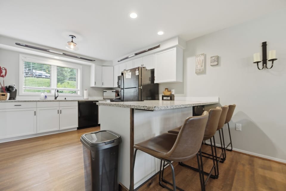Pull up a seat at the breakfast bar while meals come together in the bright, fully equipped kitchen. (Hedges)