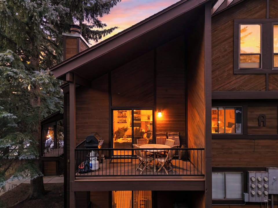 Close-up of a private balcony deck on the exterior of the cabin at twilight.