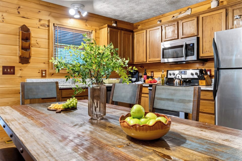 Detailed view of the dining table centerpiece and surrounding equipped kitchen cabinets.