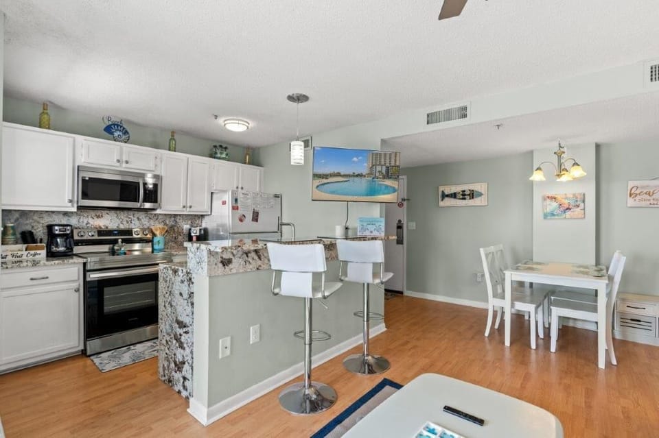 Spacious Living Area with Lounge, Dining Table, and Kitchen