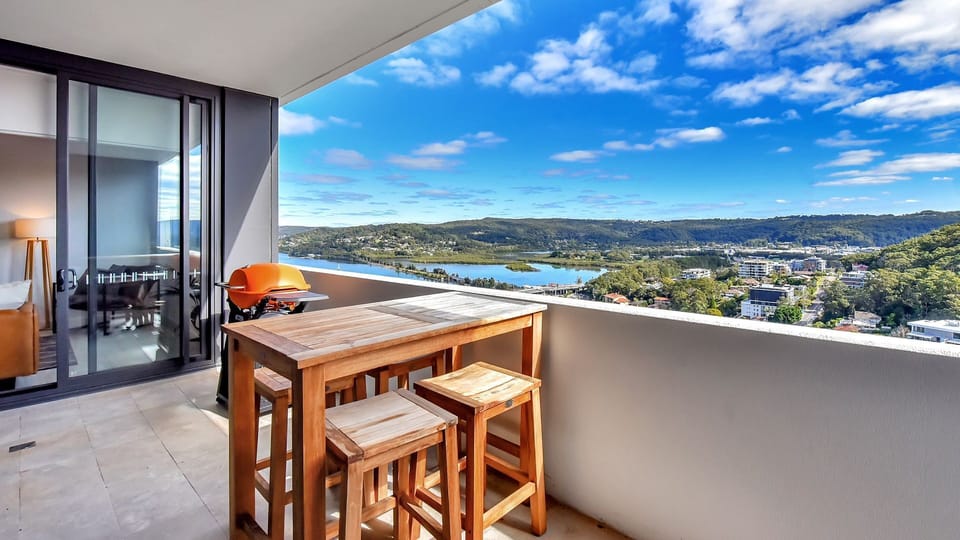 Private balcony with outdoor dining and sweeping water views.
