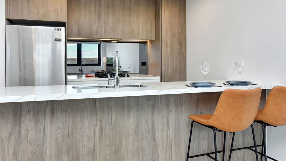 Contemporary kitchen with breakfast bar and quality appliances.