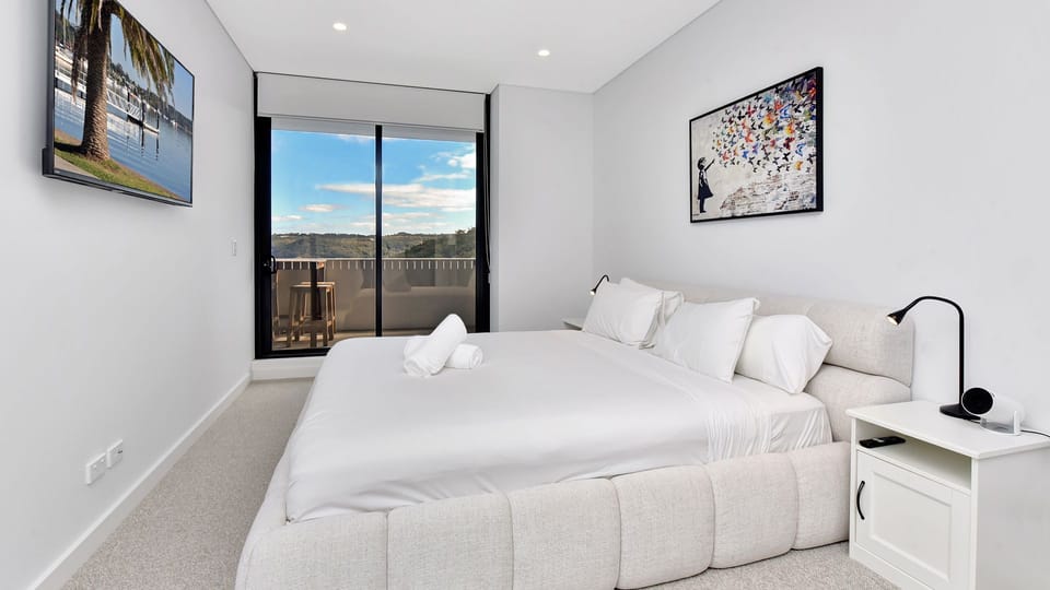 Peaceful queen bedroom with city and water views.