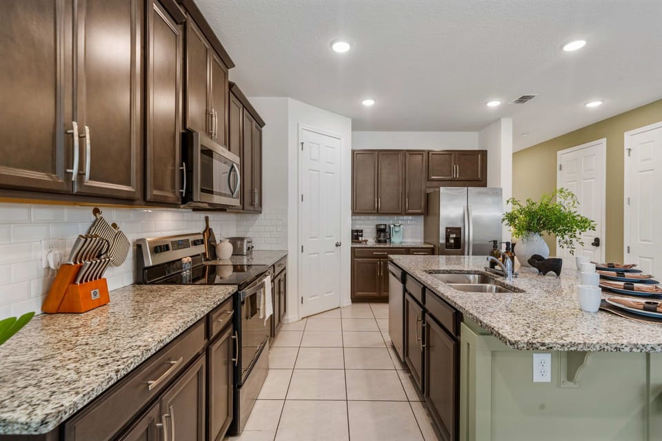 Modern kitchen with stainless steel appliances and ample workspace.