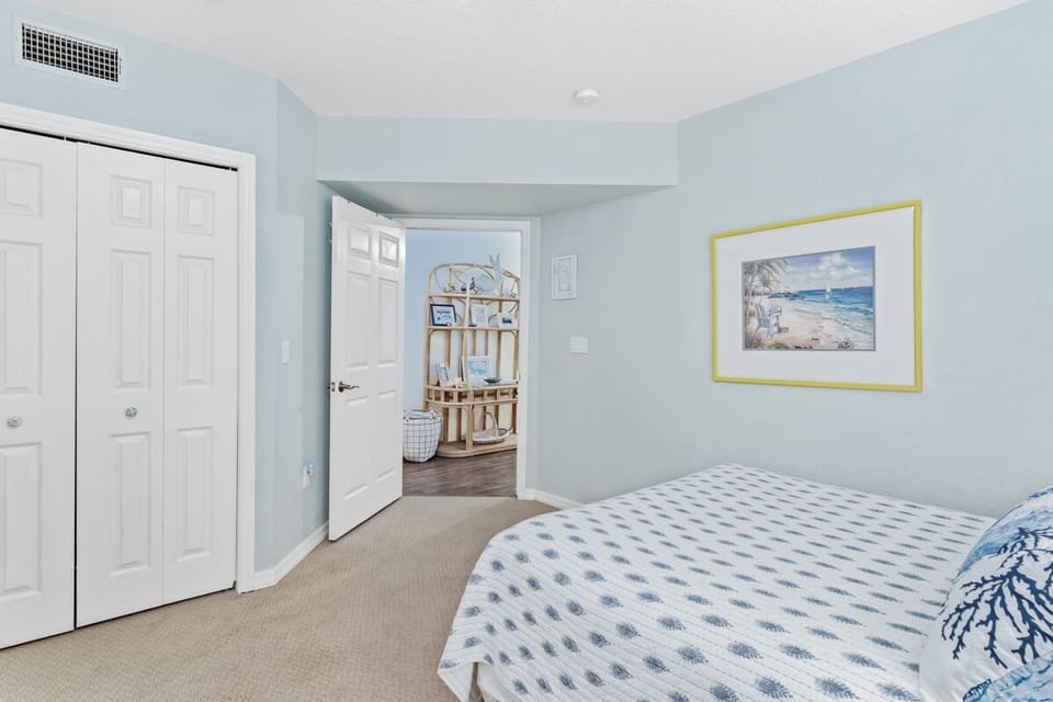 Wake up in your tranquil coastal bedroom, where soft blue walls and ocean artwork create the perfect seaside sanctuary for restful nights.