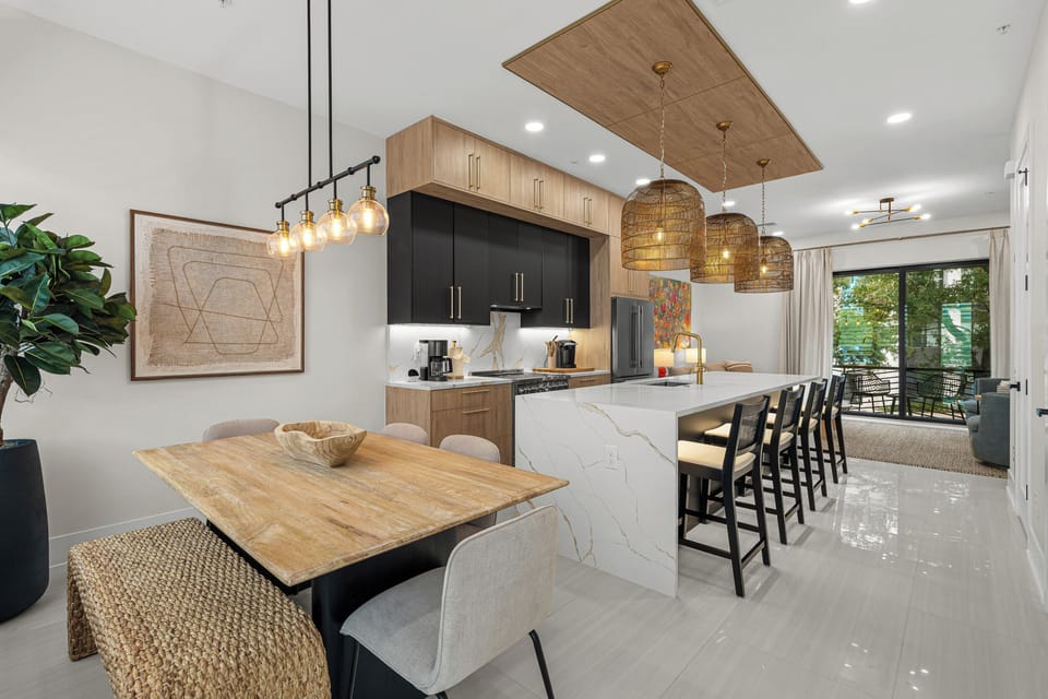 Your gourmet kitchen invites you to gather, cook, and connect. Sleek marble countertops, modern appliances, and an open design flow seamlessly into comfortable seating, perfect for shared meals and cherished moments.
