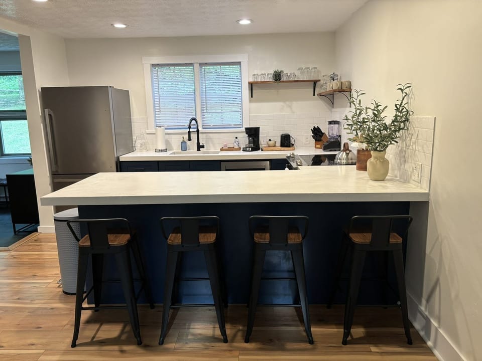Beautiful kitchen with concrete counter tops & bar seating