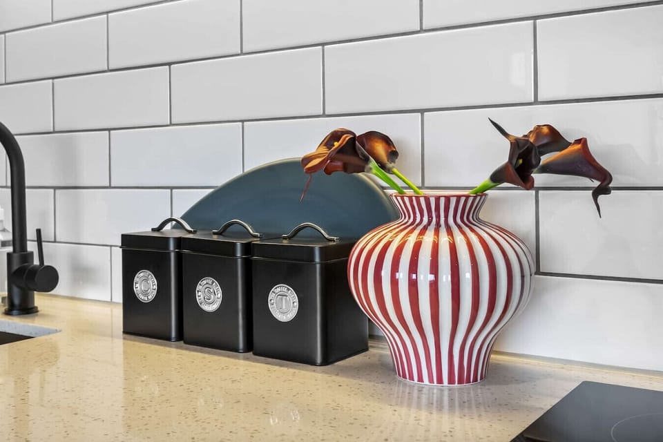 Modern, fully equipped kitchen with sleek finishes and all essentials for preparing meals during your stay.