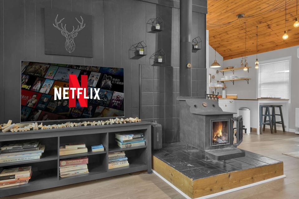Living room with French doors to the deck and mounted flat-screen TV