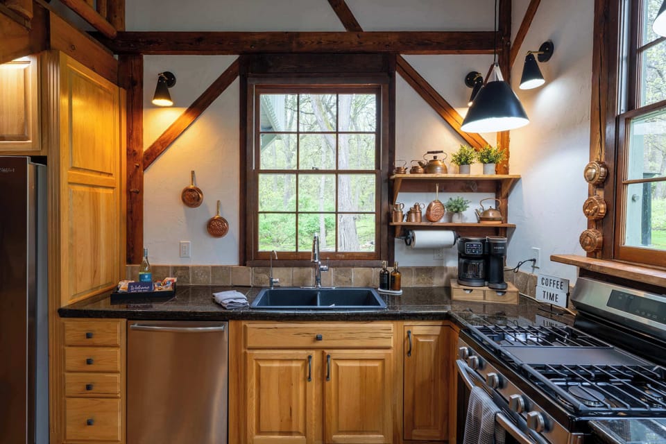 Kitchen coffee and cleanup station with a farmhouse-style sink, dishwasher and gas range