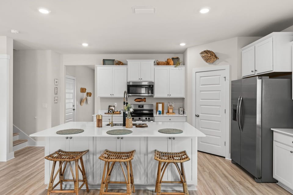 Your bright, fully equipped kitchen awaits with a spacious island, modern stainless appliances, and plenty of counter space—perfect for cooking together or enjoying morning coffee before your next adventure.