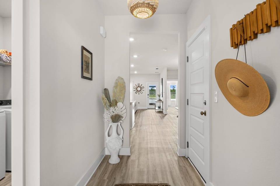 Your inviting entryway features sunlit spaces and elegant touches, creating a warm first impression that sets the tone for your entire stay. Follow it past the dining area to the bunkbed room.
