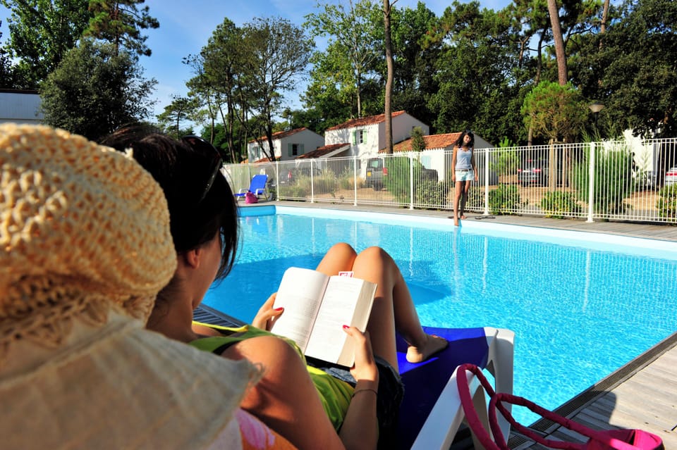 Trade the beach for a quieter afternoon by the pool, book in hand and pines swaying overhead.