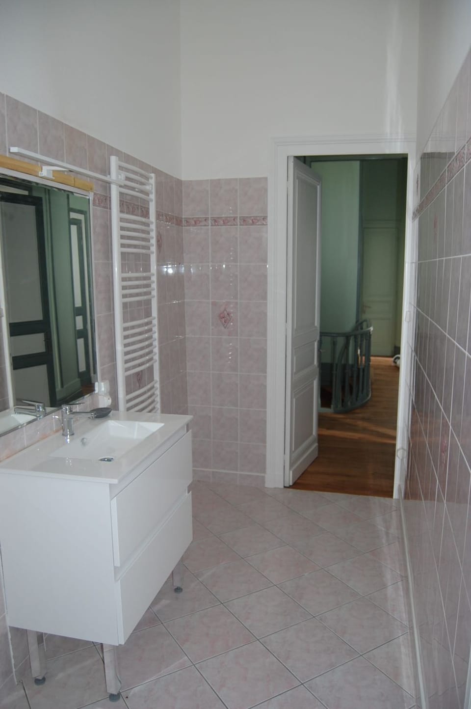 Natural light and a heated towel rail complete this bright, practical bathroom serving the estate's family suite.