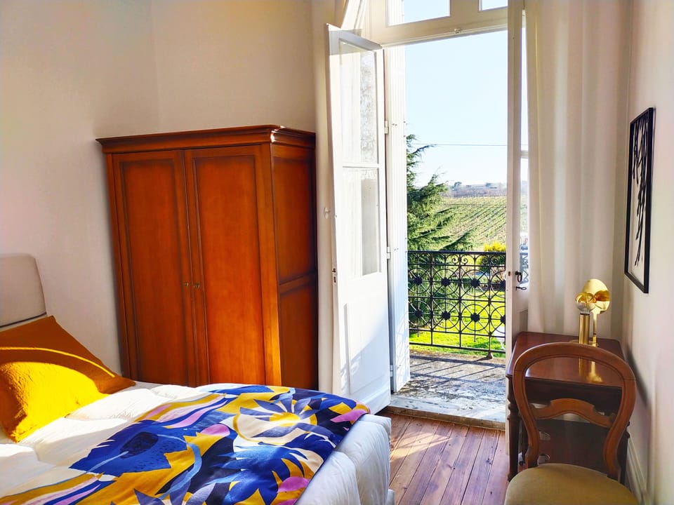 One of four decorated bedrooms, with direct balcony access and views over the vineyards and surrounding countryside.