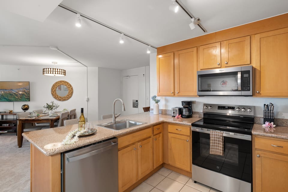 Prepare meals with ease in the fully equipped kitchen featuring stainless steel appliances, granite countertops, and ample cabinet space.