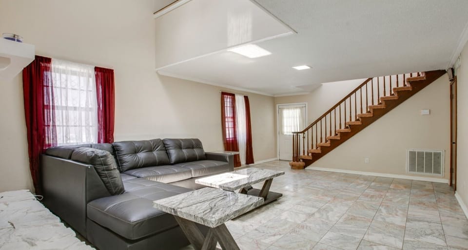  interior staircase, handrail, indoor, climate control, couch, living area.
