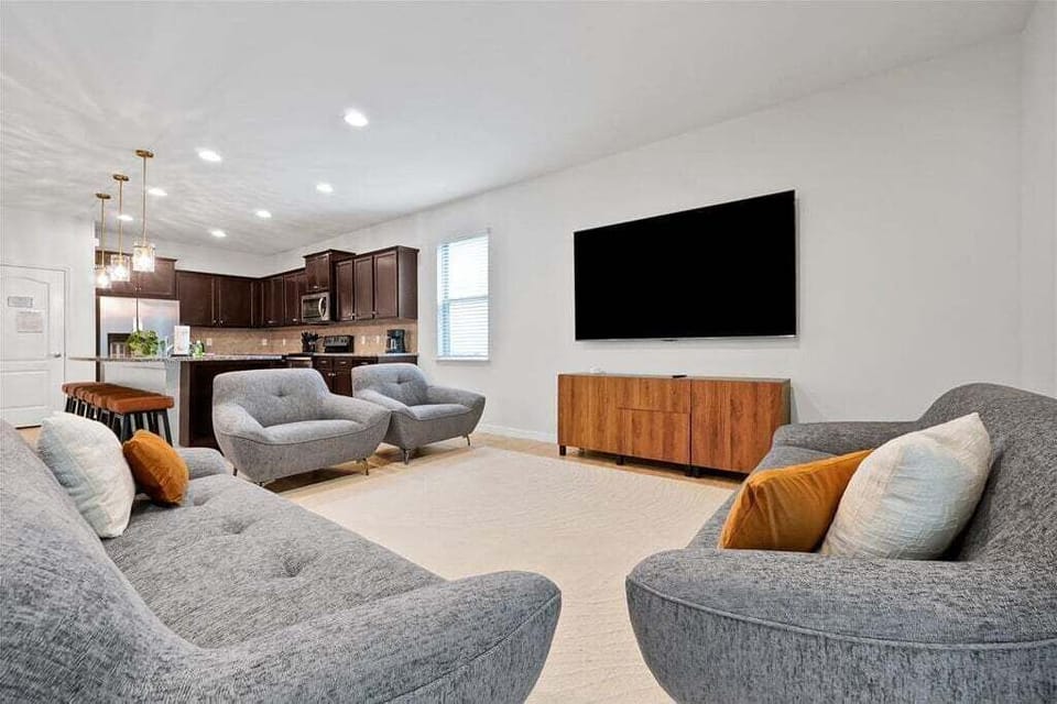 Designed for comfort and connection, this inviting space features plush seating, a large Smart TV, and plenty of room for everyone to relax after a fun-filled day exploring Orlando.