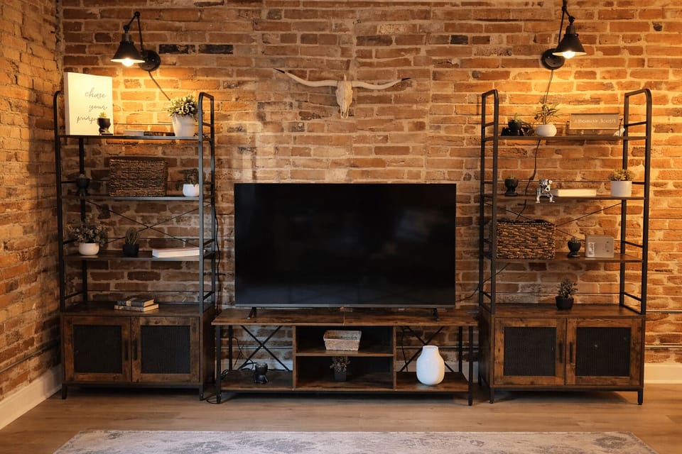 Smart TV entertainment area framed by exposed brick