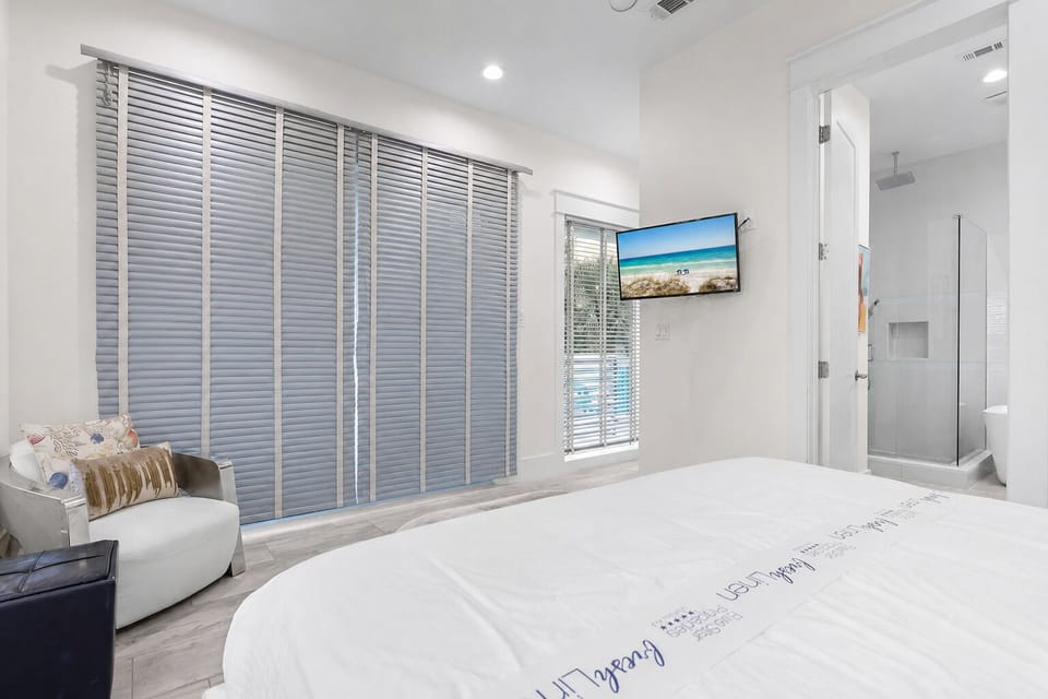 2nd Floor - A second view of Bedroom 3 highlights the King bed, 55-inch 4K Smart TV, and access to its private en-suite bathroom and balcony.