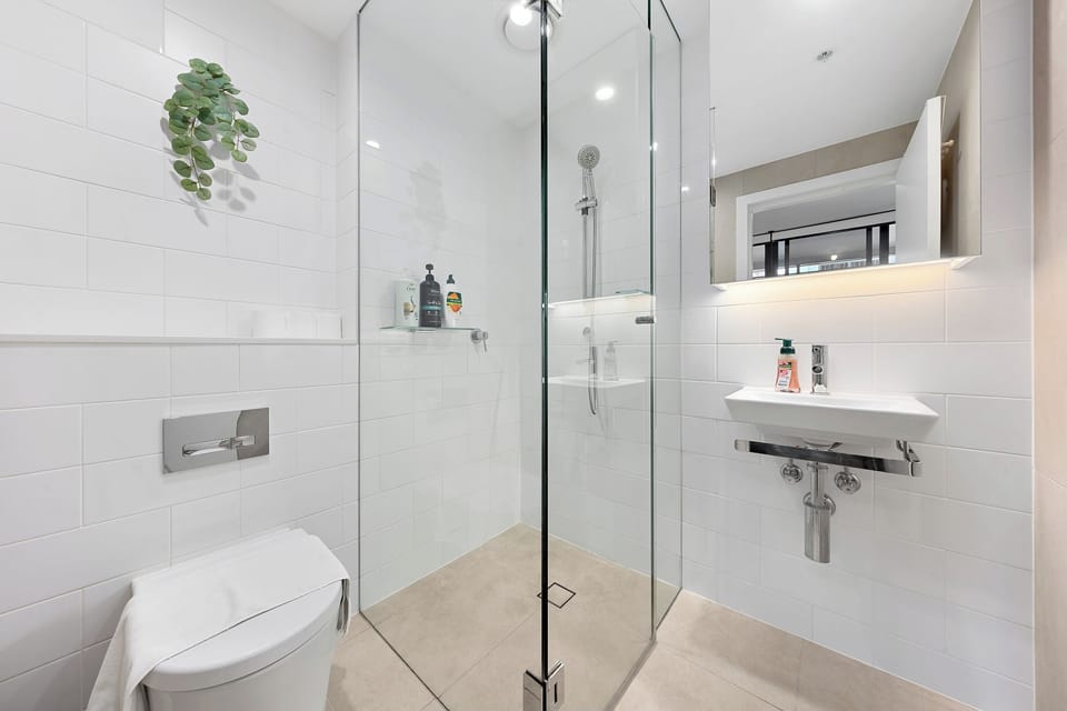 Bright modern bathroom with glass walk-in shower and sleek finishes