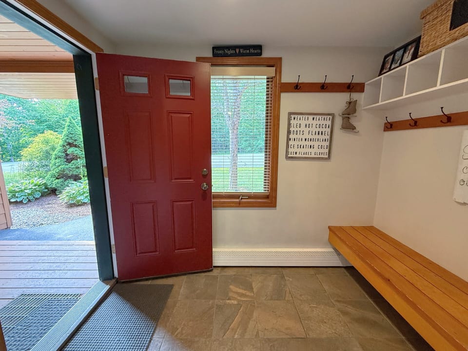 Spacious entryway with hooks and storage.
