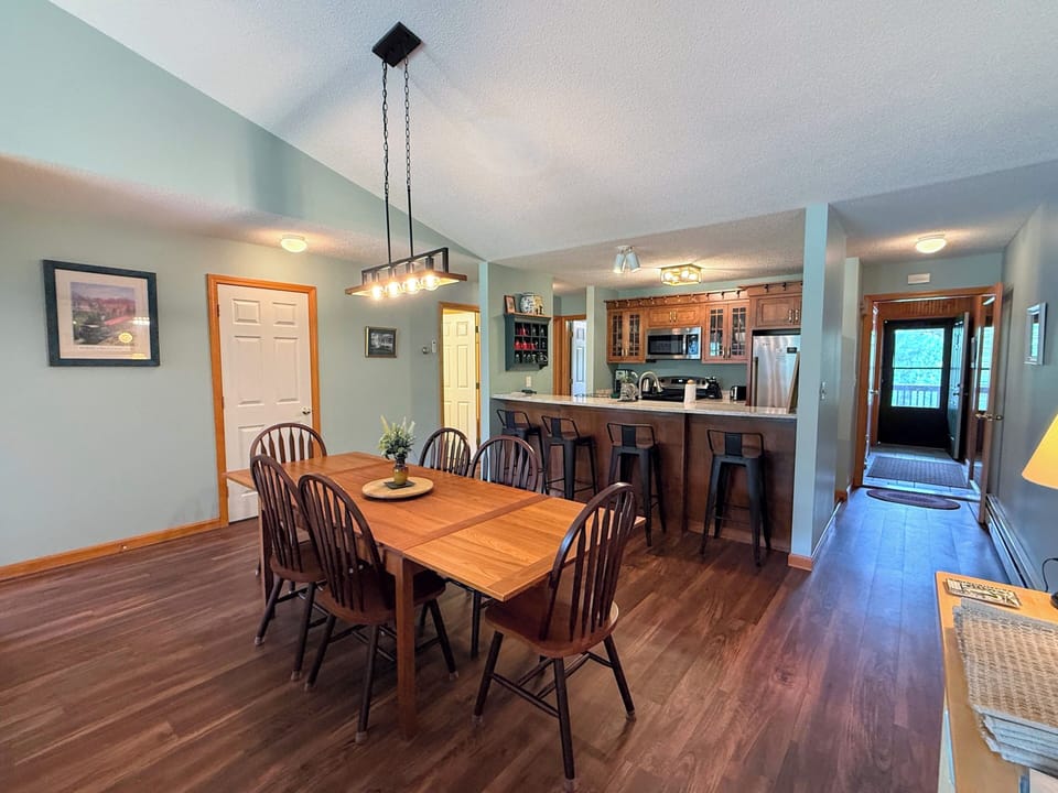 Dining table with seating for 6 + an extra chair and 4 stools at the breakfast bar.