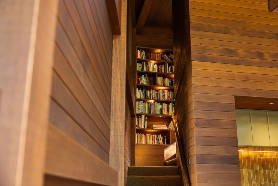 Stairs lead up to the library and bedroom